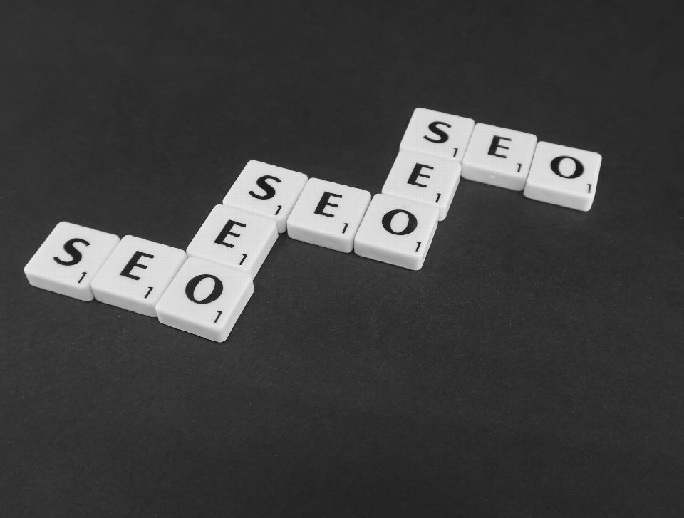 SEO spelled with Scrabble tiles on a black surface, representing search engine optimization concepts. SEO spelled with Scrabble tiles on a black surface, representing search engine optimization concepts.