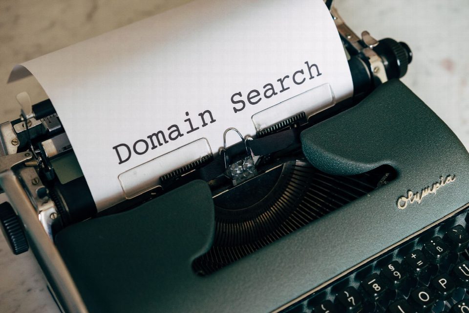Close-up of a vintage typewriter with paper displaying 'Domain Search' text for conceptual design. Close-up of a vintage typewriter with paper displaying 'Domain Search' text for conceptual design.
