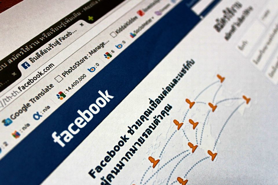 Close-up view of a Facebook webpage displayed on a browser with social media icons.